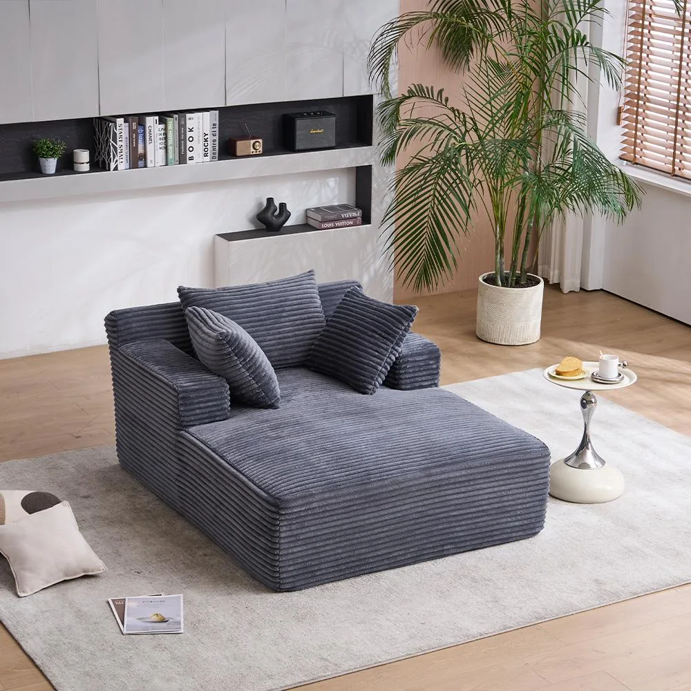 Grey corduroy chaise longue sofa bed with throw pillows and armrests