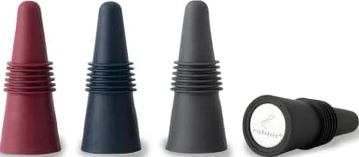 Four multicolored wine bottle stoppers with stainless steel tops and silicone bases arranged together