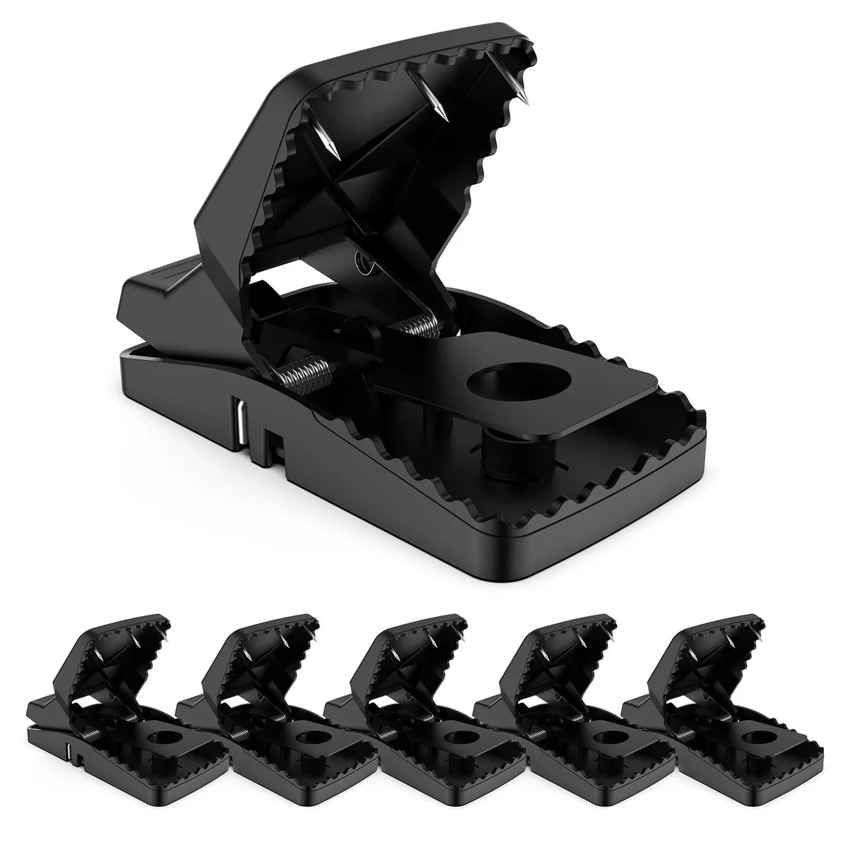 Six plastic snap traps with serrated jaws and spikes on a plain background