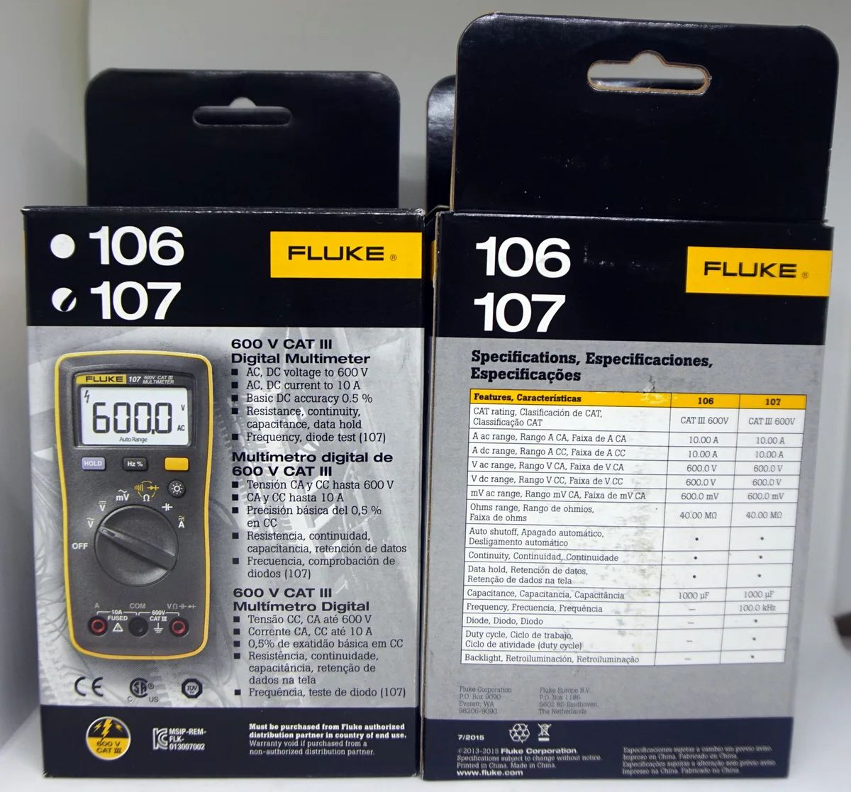 Compact yellow handheld digital multimeter with backlit display and test leads