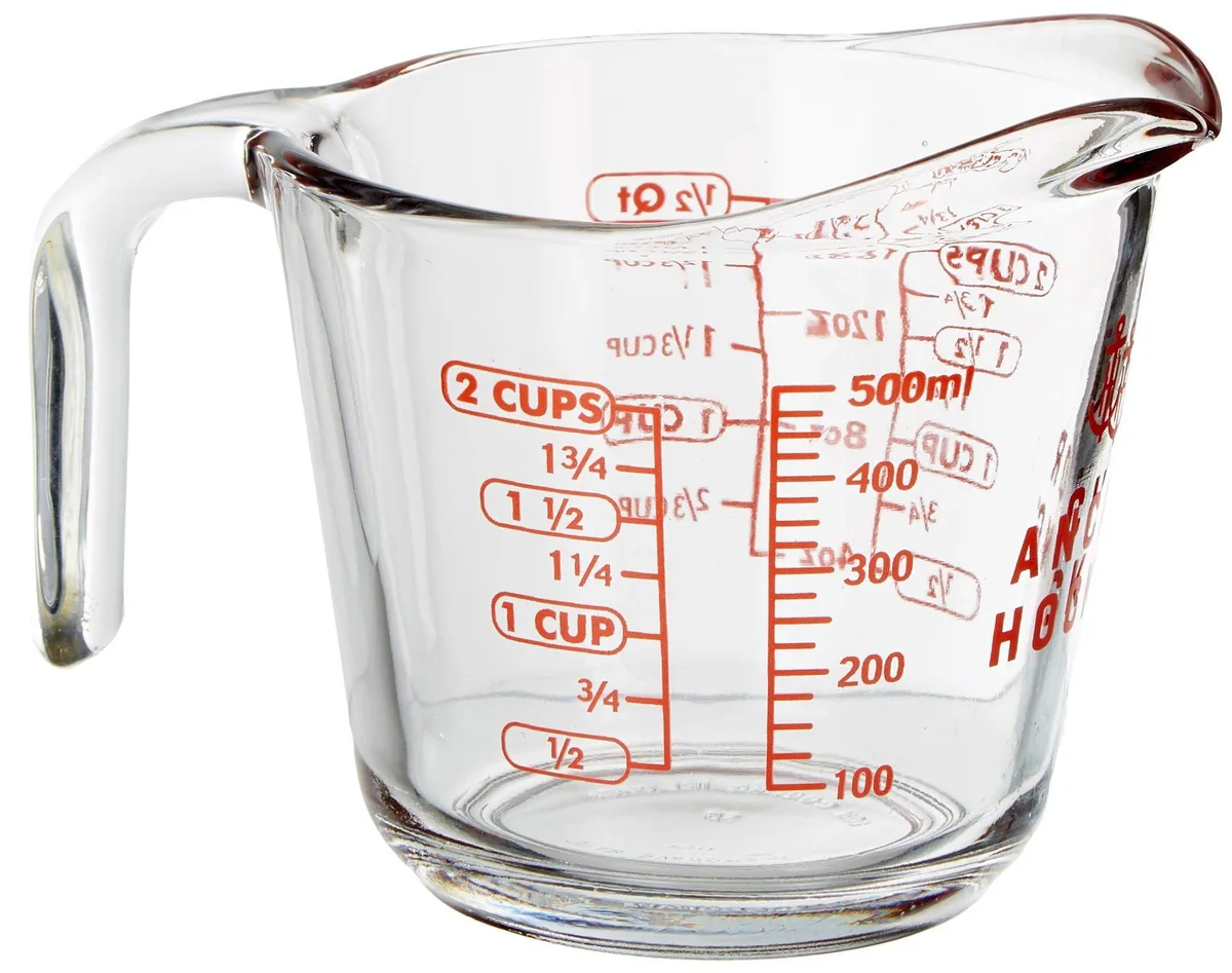 Clear 16-ounce glass measuring cup with red markings, handle and spout