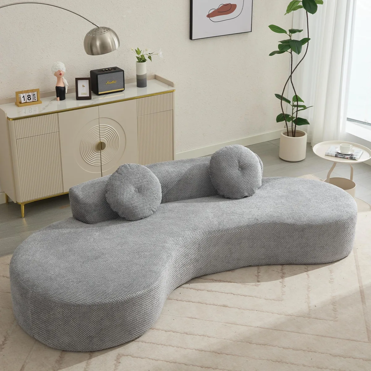 Large curved gray corduroy sofa with two pillows, low back and deep seat