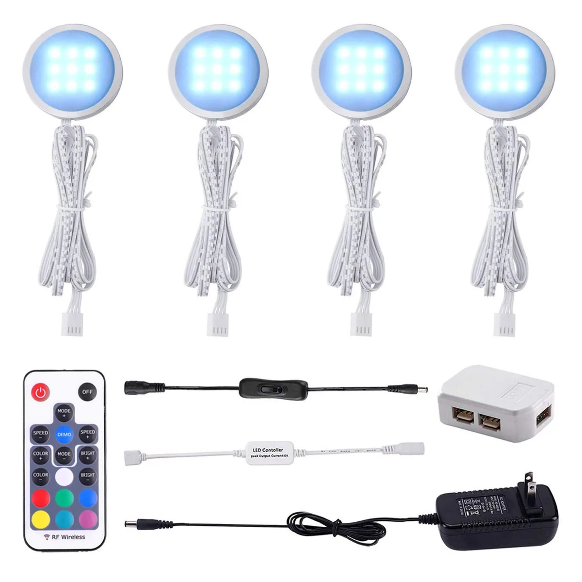 Four slim aluminium puck lights with plastic lenses and a remote control