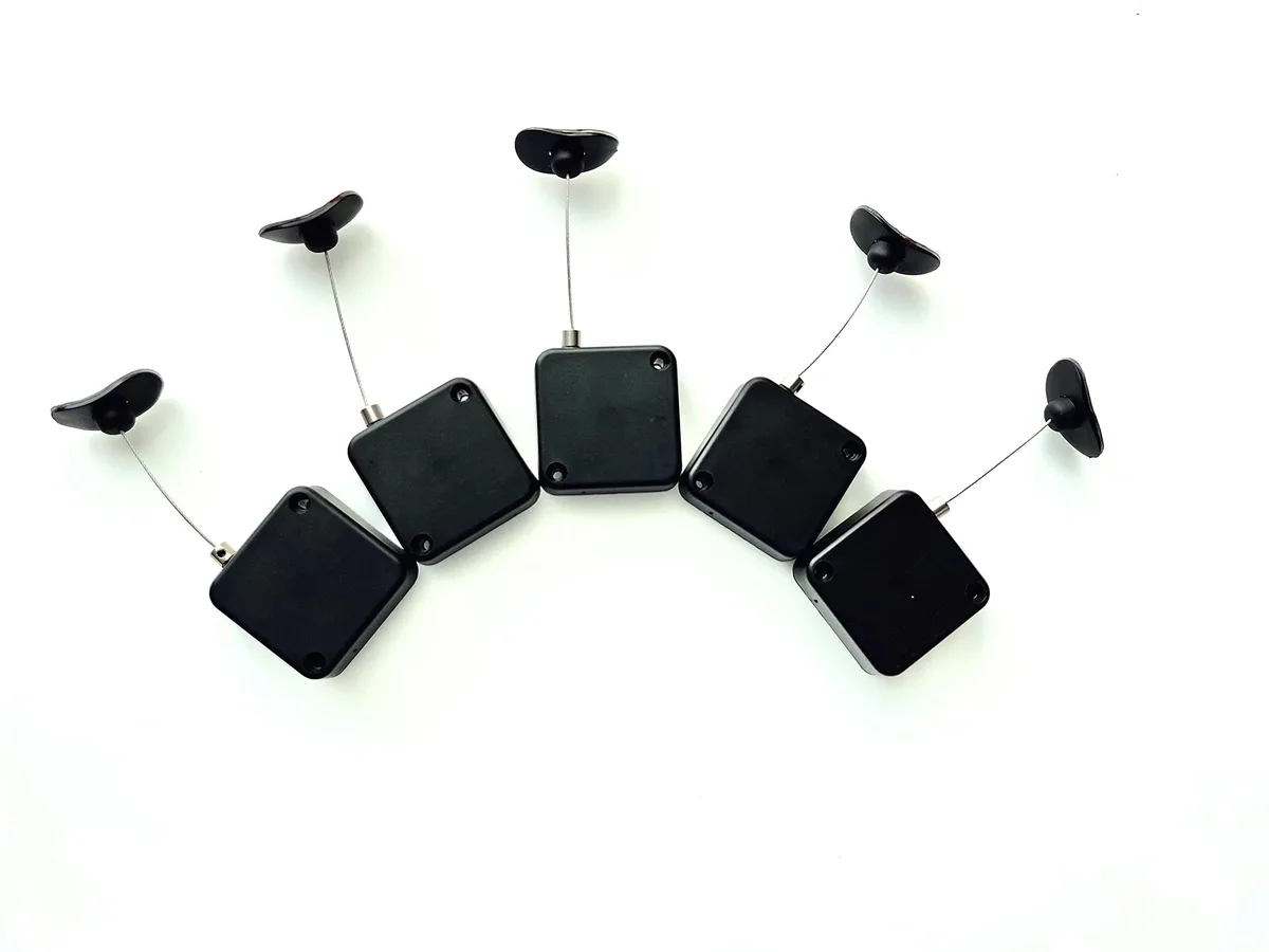 Five retractable cable locks with adhesive anchors and steel cables