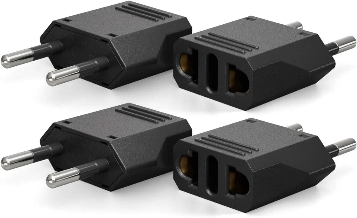Four black Type C travel plug adapters in a pack