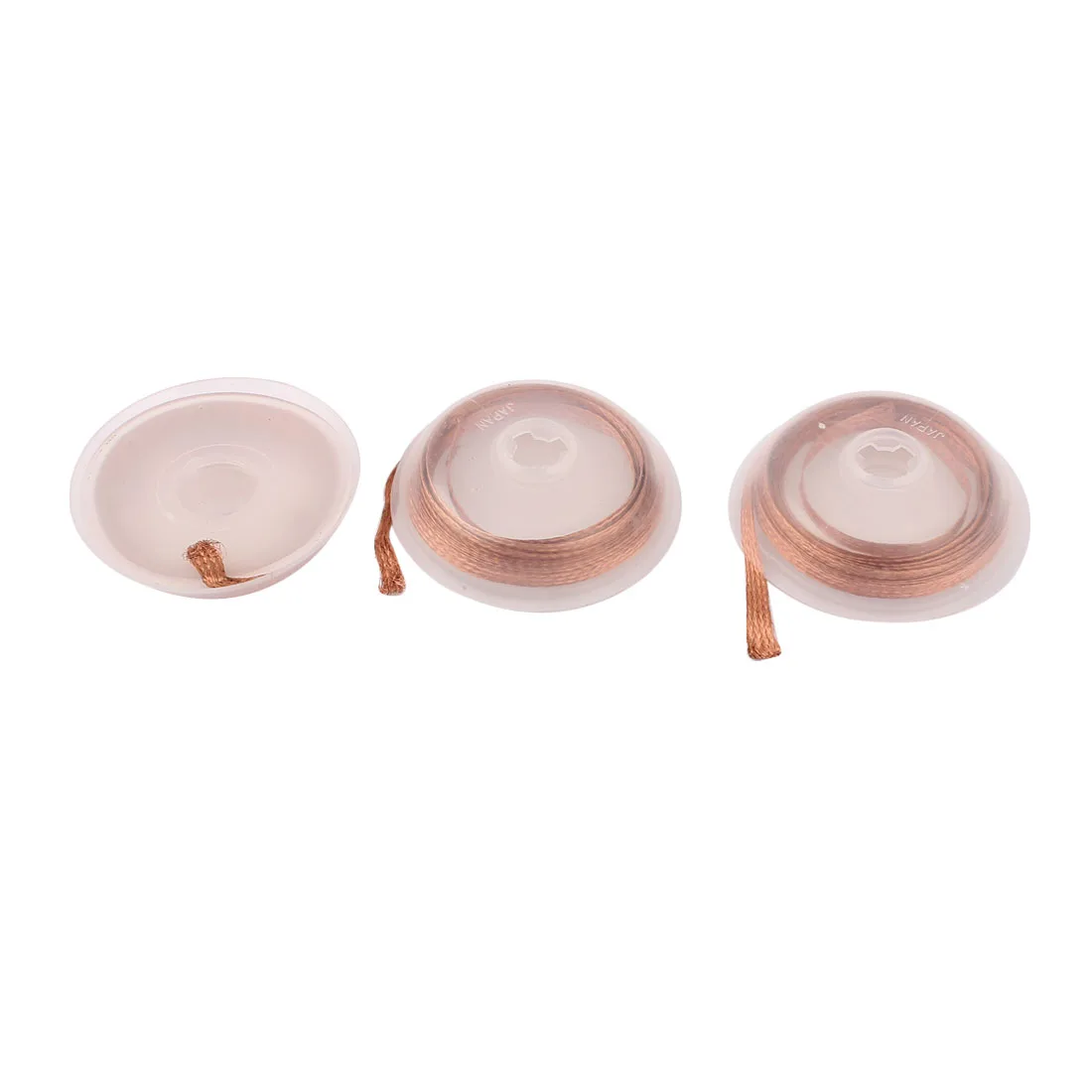 Three copper-coloured braided wicks on white plastic spools