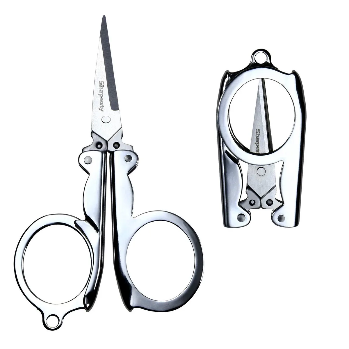 Two silver stainless steel folding scissors, folded closed, compact and lightweight
