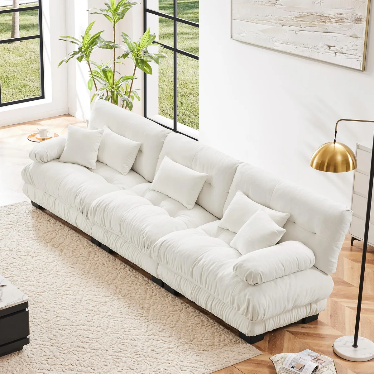 White chenille modular sectional sofa with round bolster armrests and deep seat cushions