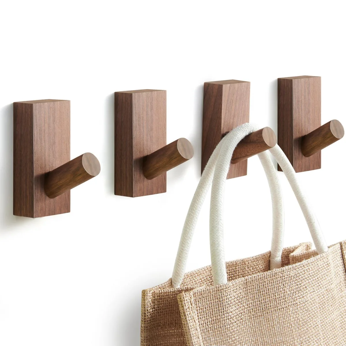 Four walnut wooden wall hooks with smooth finish