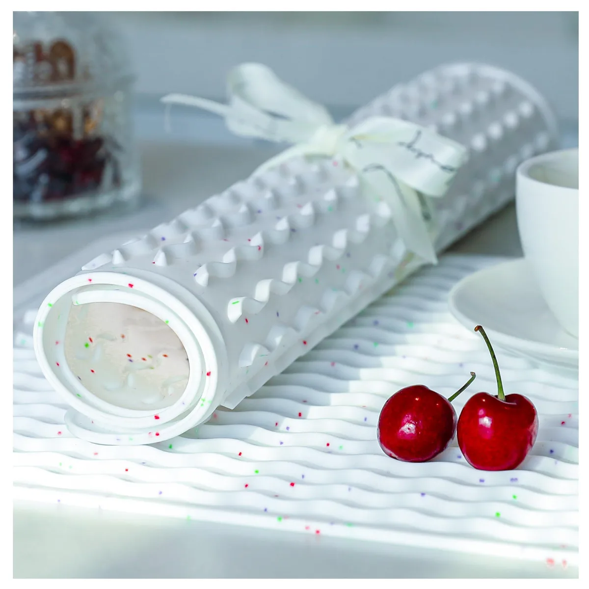 Two flexible ribbed silicone mats in assorted colours lying flat on a countertop