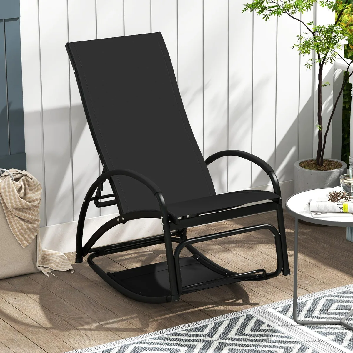 Black outdoor rocking chair with adjustable backrest, curved metal frame and grey fabric seat