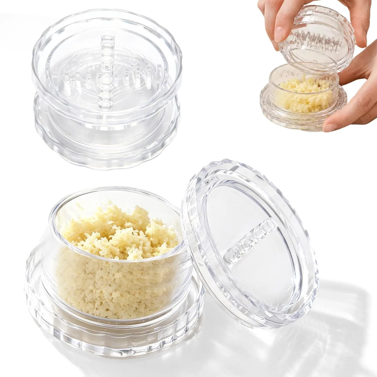 Two white plastic garlic twisters with clear bodies and interlocking teeth