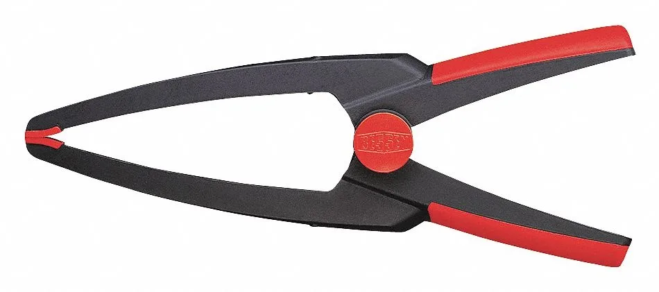 Orange spring clamp with black ergonomic handles and white needle-nose jaw tips
