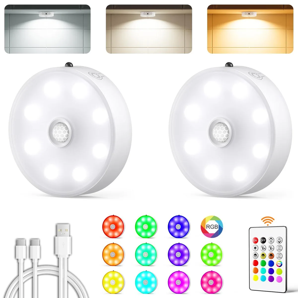 Two white round puck lights with clear prismatic faces and a remote control