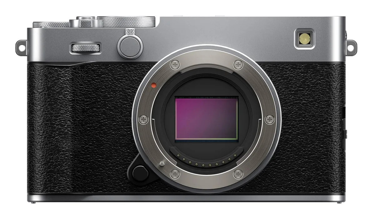 Silver mirrorless camera body with textured grip, top dials and a 3.0 inch tilting touchscreen