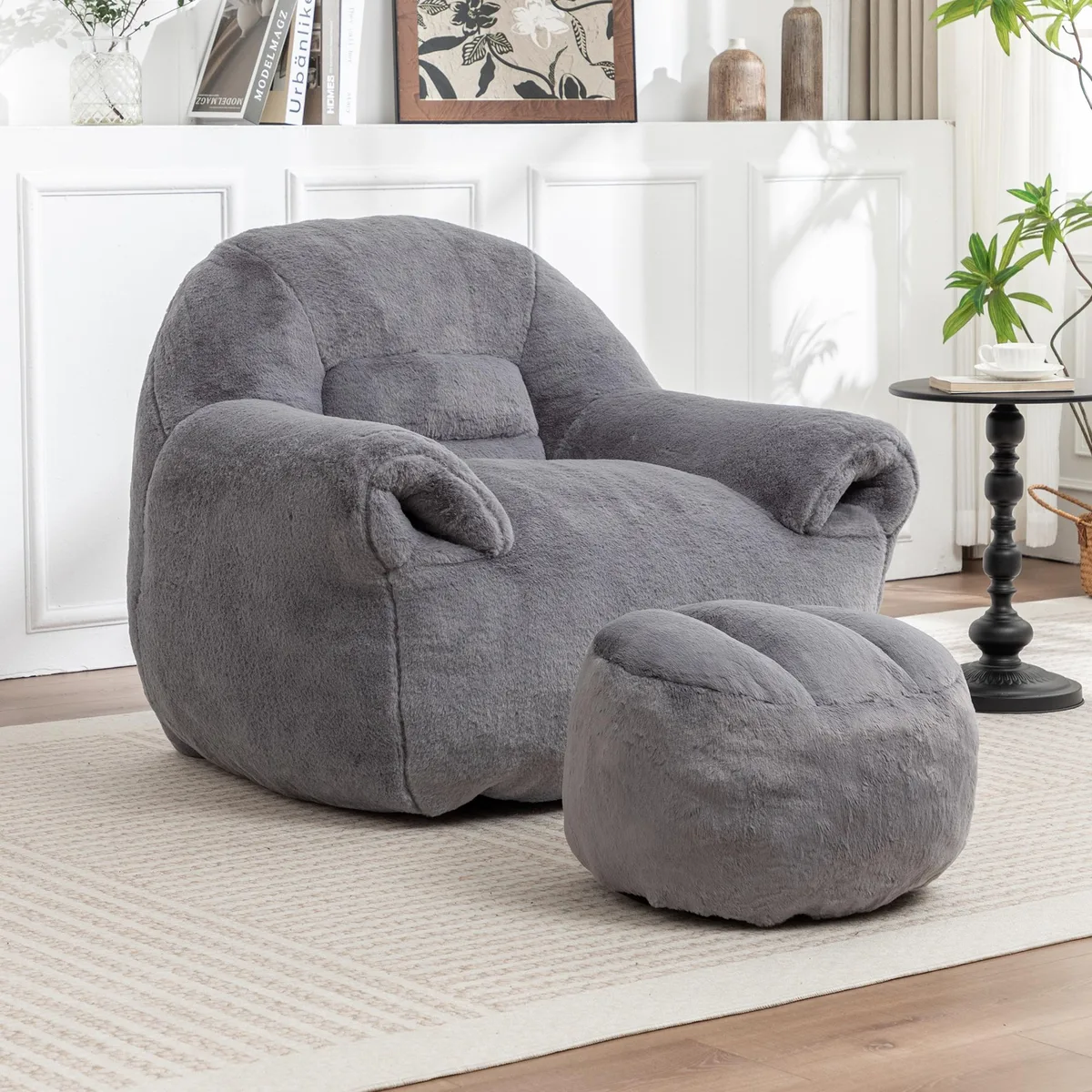 Dark grey faux fur bean bag sofa with matching footstool, rounded backrest, floor-level profile