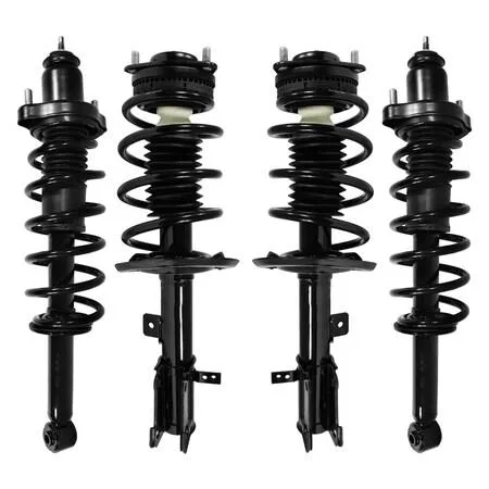 Four silver strut assemblies with black coil springs and silver mounts on a white background