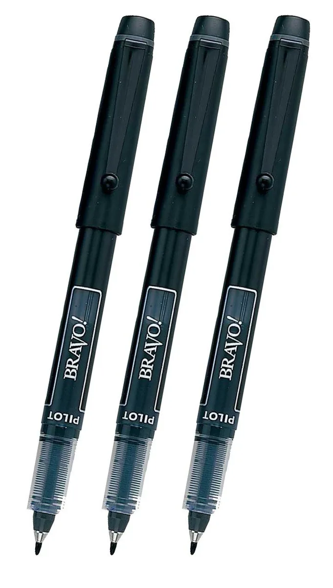 Three black marker pens with bold chisel tips lying side by side