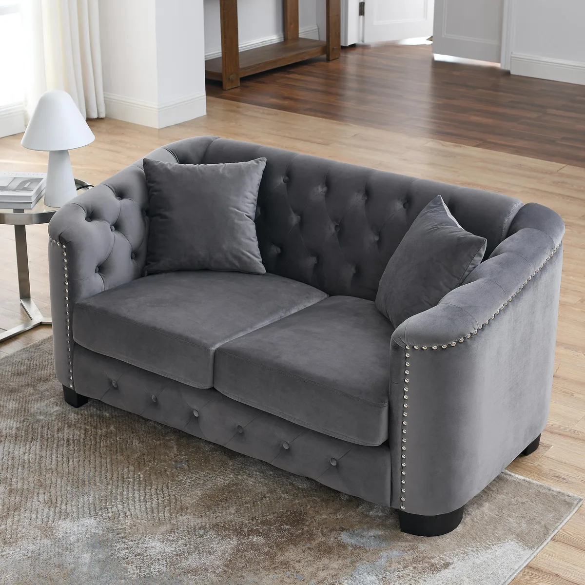 Grey velvet Chesterfield sofa with tufted back, nailhead arms and two cushions