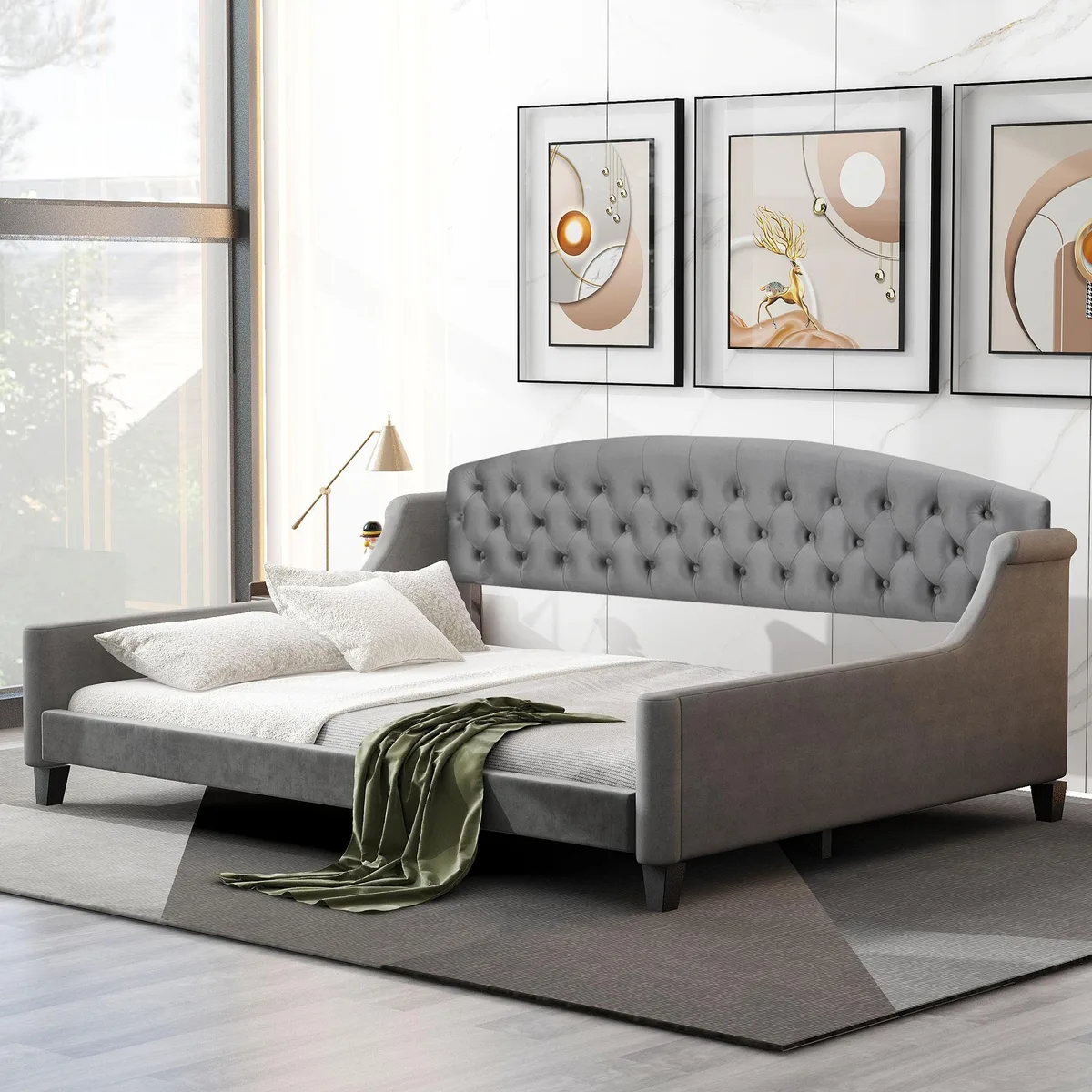 Gray upholstered daybed with tufted buttons and wooden slats