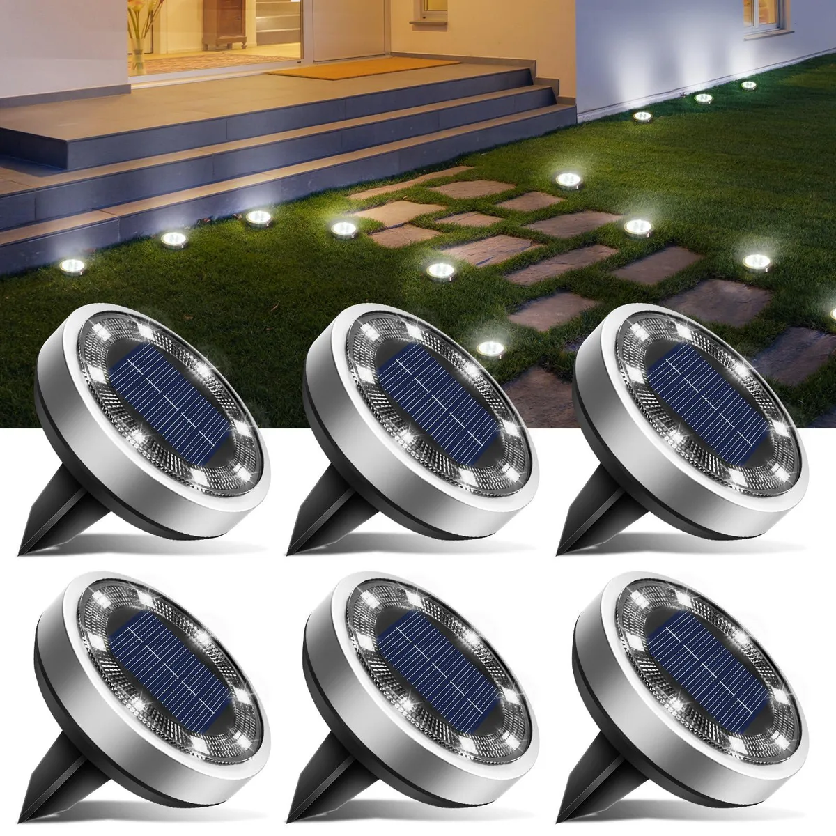Six stainless-steel solar disc lights with ground spikes laid on grass