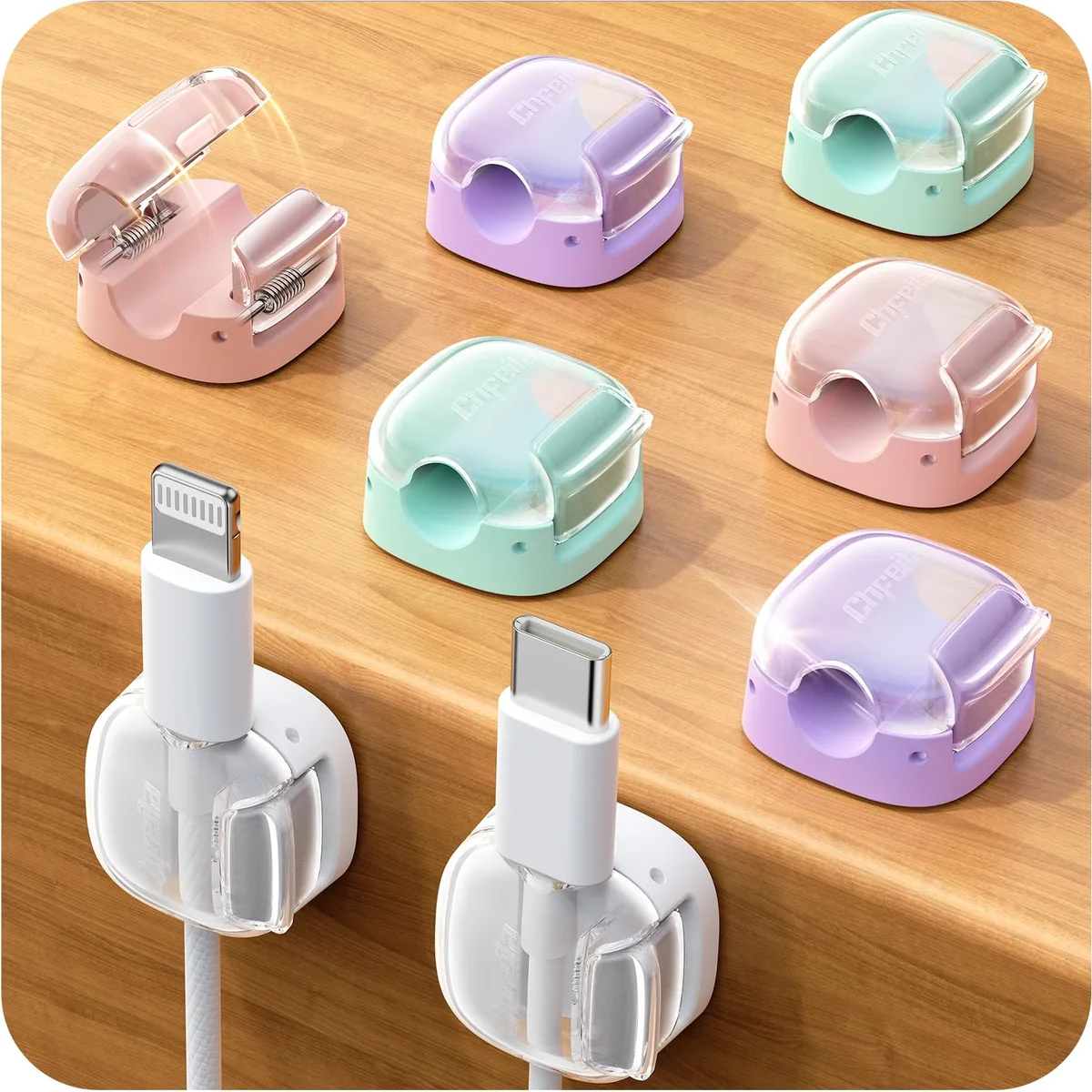 Eight small green spring clips with adhesive backs