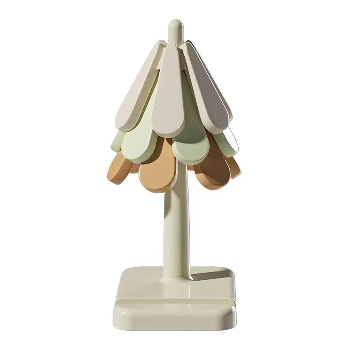 A three-tier cream and earth-tone silicone trivet set shaped like a Christmas tree on a storage stand