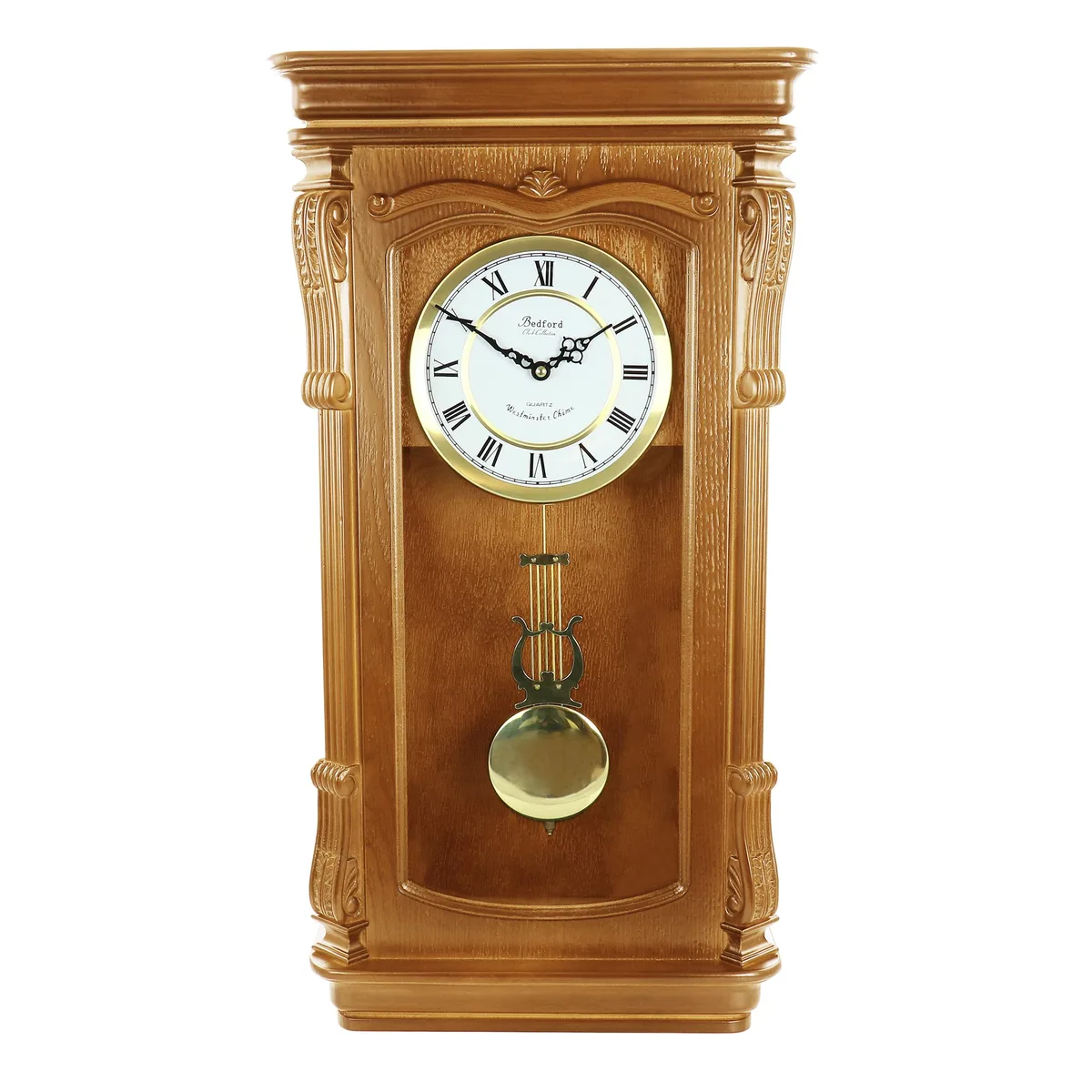 Golden oak wall clock with roman numeral dial, carved accents, and swinging pendulum