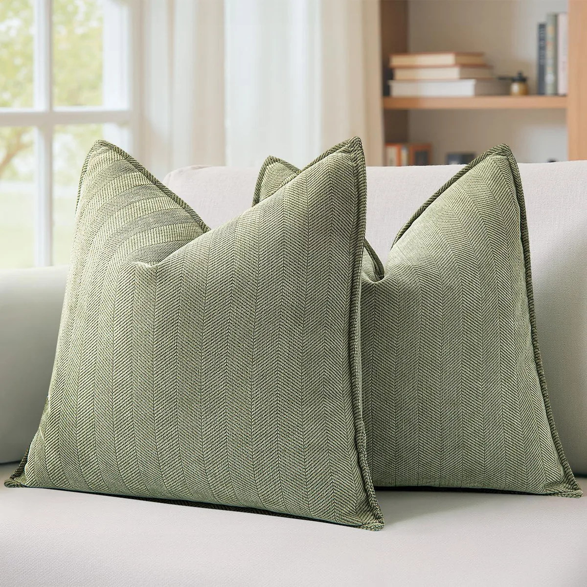 Two square sage-green chenille pillow covers with hidden heart-shaped zippers, 20 by 20 inches