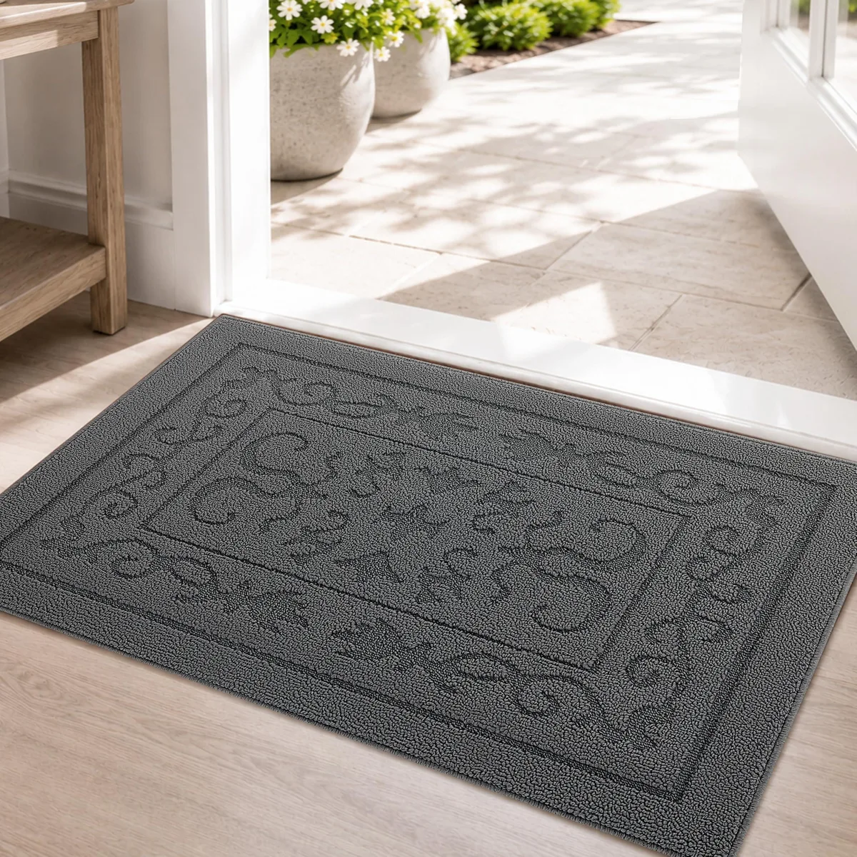 Grey rectangular door mat with floral pattern and low pile surface