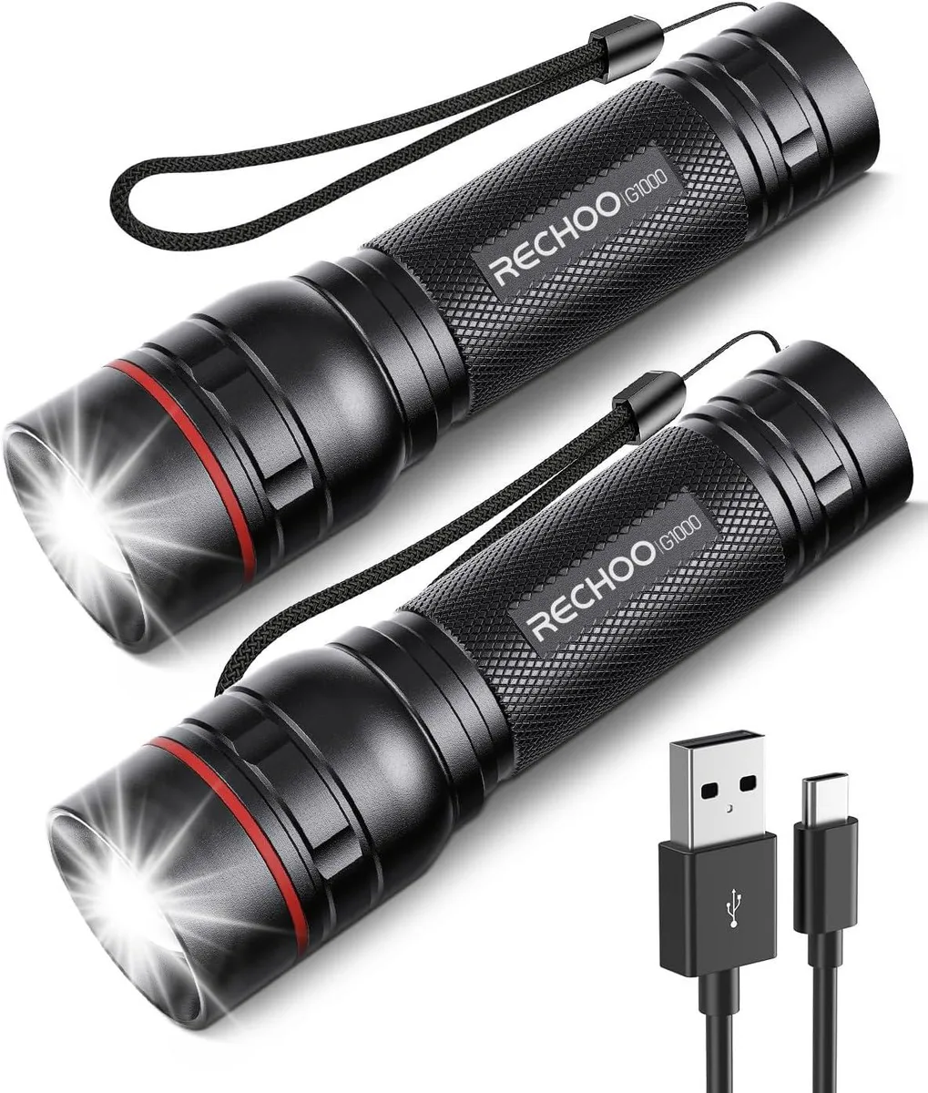 Two black cylindrical flashlights side by side with textured grips and zoomable heads