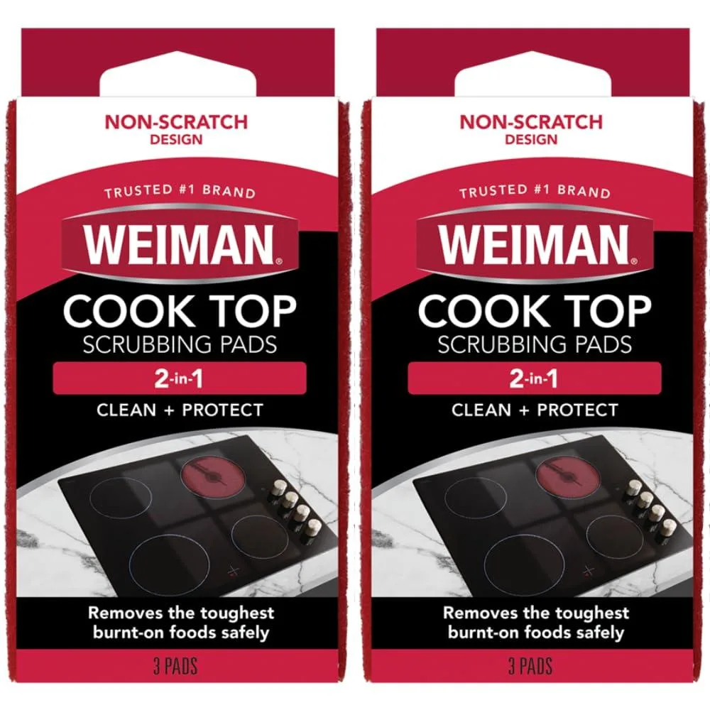Two packs of three white scrubbing pads in a rectangular box