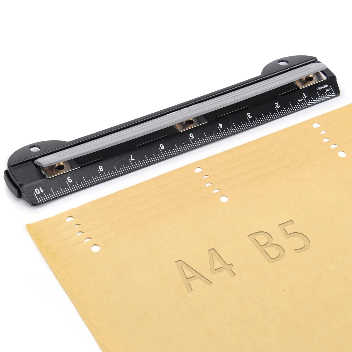 Black three-hole puncher with built-in 10-inch ruler and removable chip tray