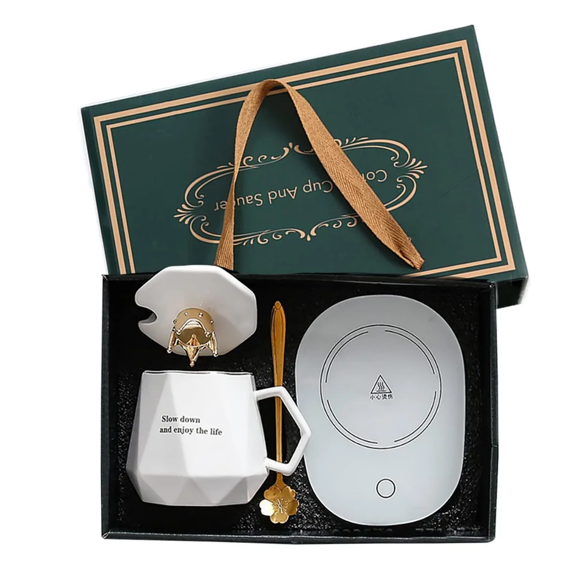 White electric coffee warmer with ceramic mug, gold-trimmed crown lid and metal spoon