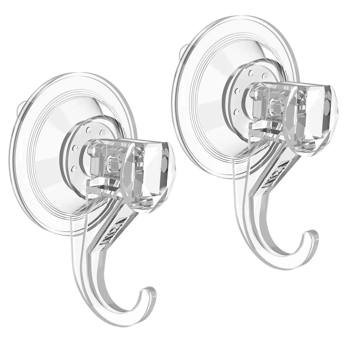 Two clear plastic suction cup hooks on a smooth surface