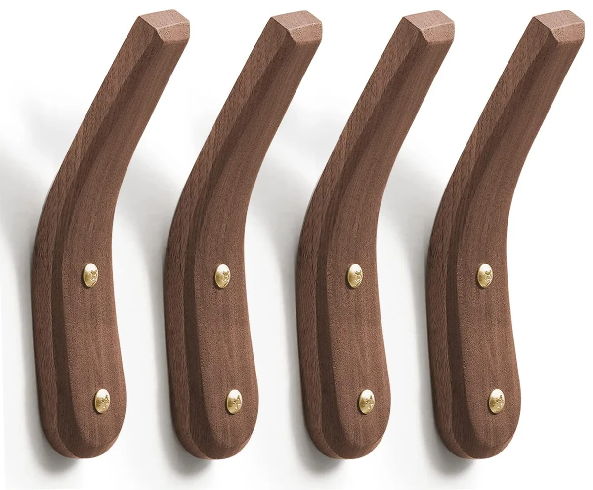 Four natural walnut wall hooks with visible grain, rectangular profile, mounted hardware included