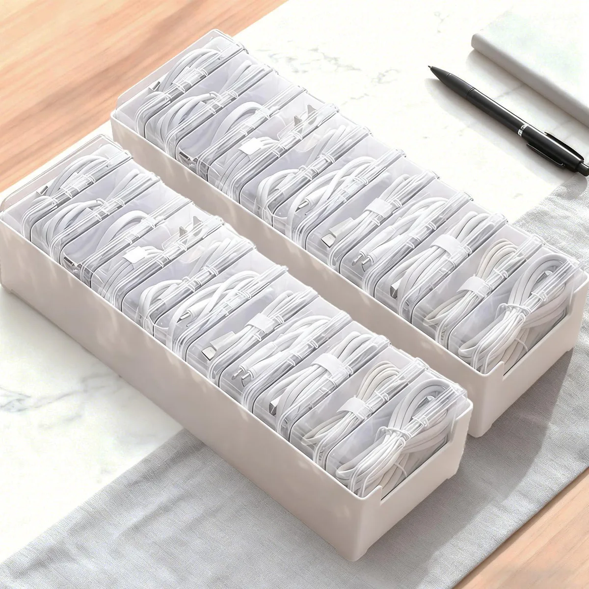Two clear plastic tabletop boxes each with eleven compartments stacked together