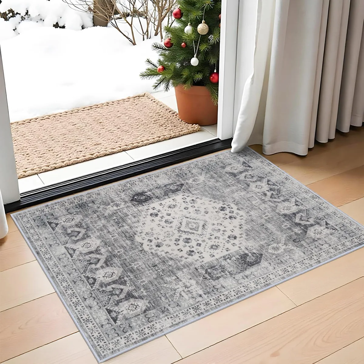 Grey polyester runner rug with distressed vintage pattern, rectangular low-pile surface, folded edges visible