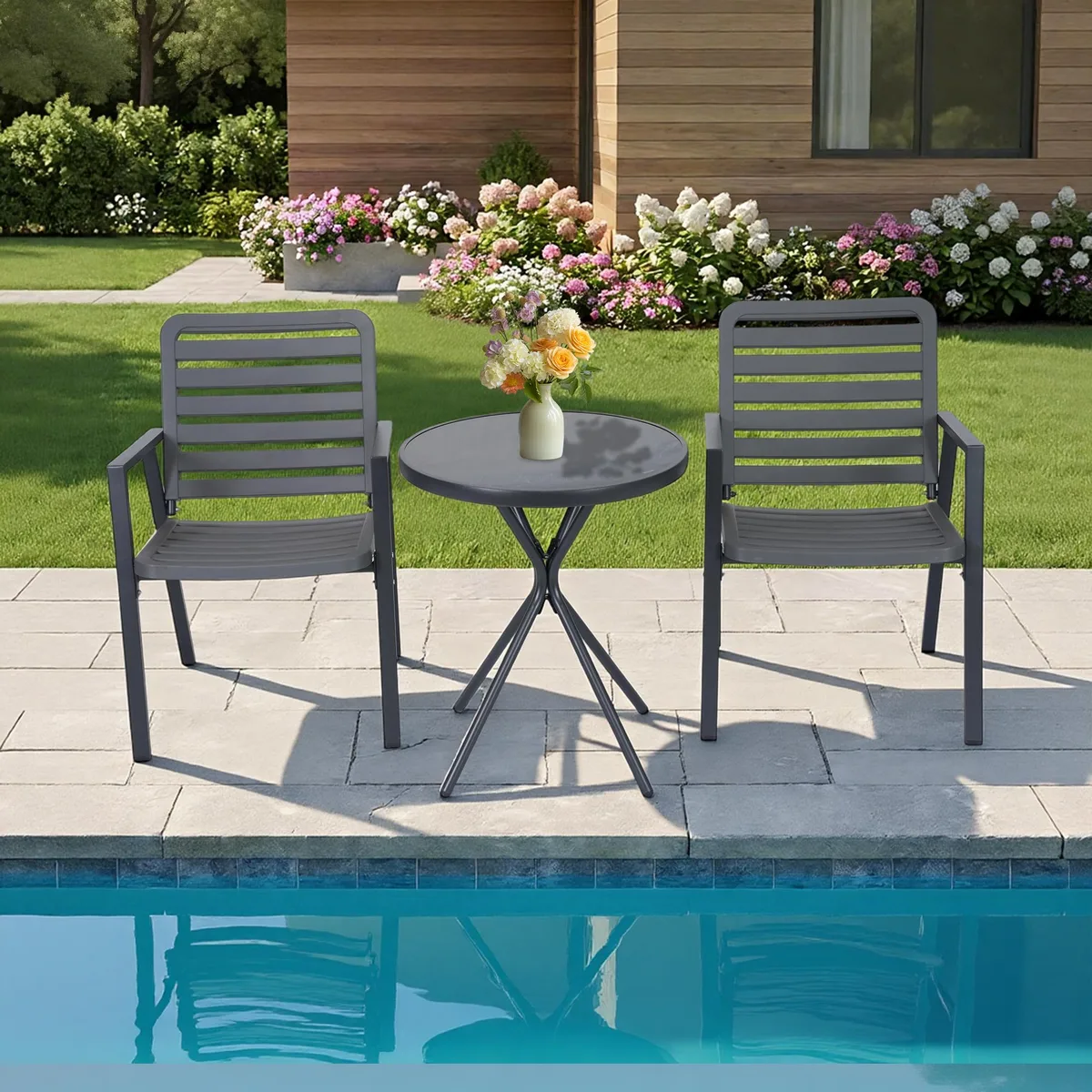 Two grey plastic slat dining chairs with black metal frames