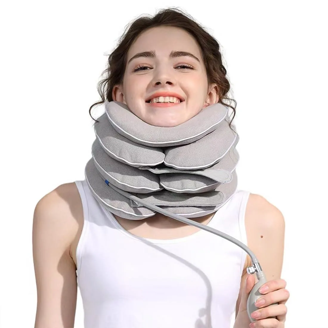 Gray inflatable neck brace with adjustable chin support and hand pump visible