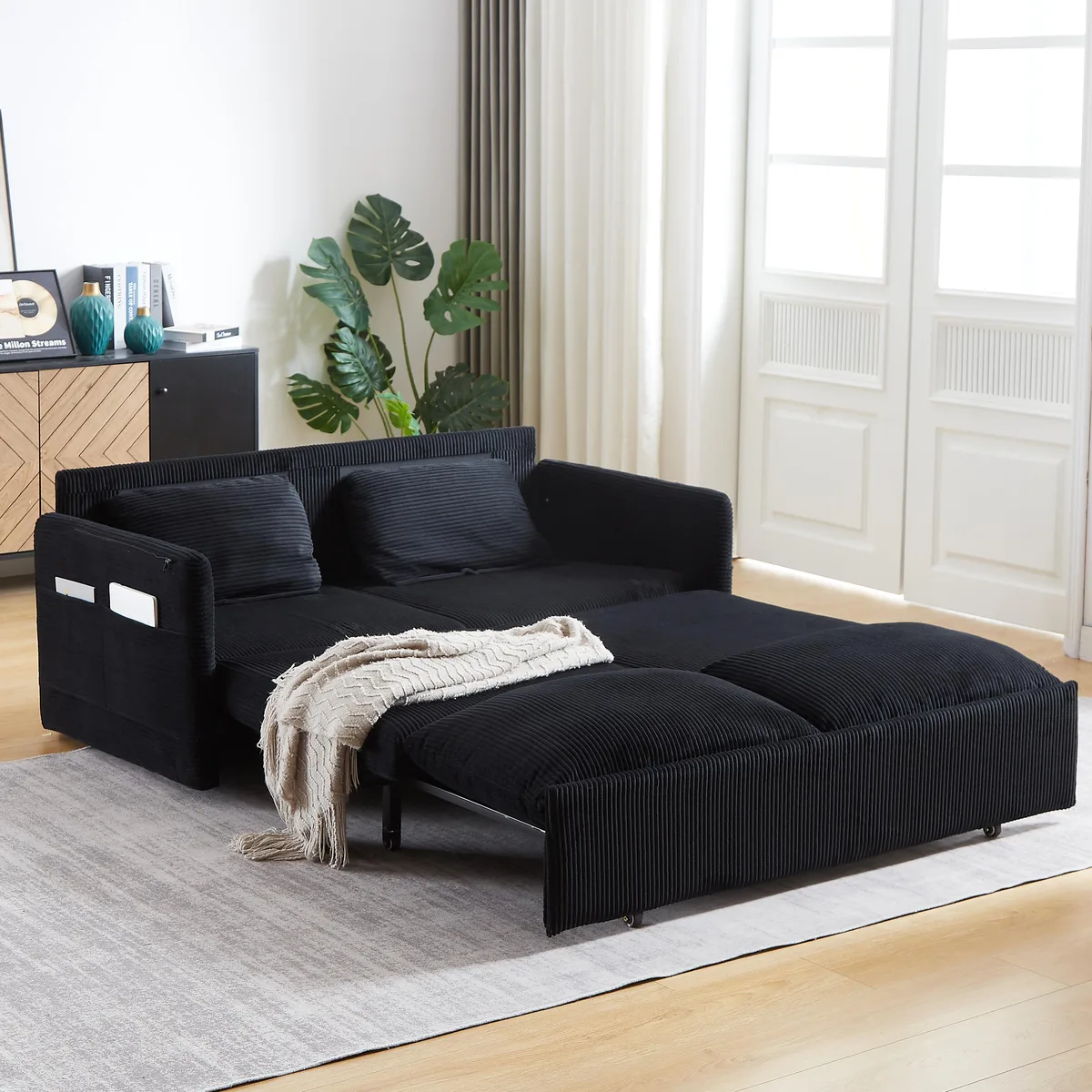Black corduroy sleeper sofa bed with pullout mechanism and side pockets, 64.5 inches