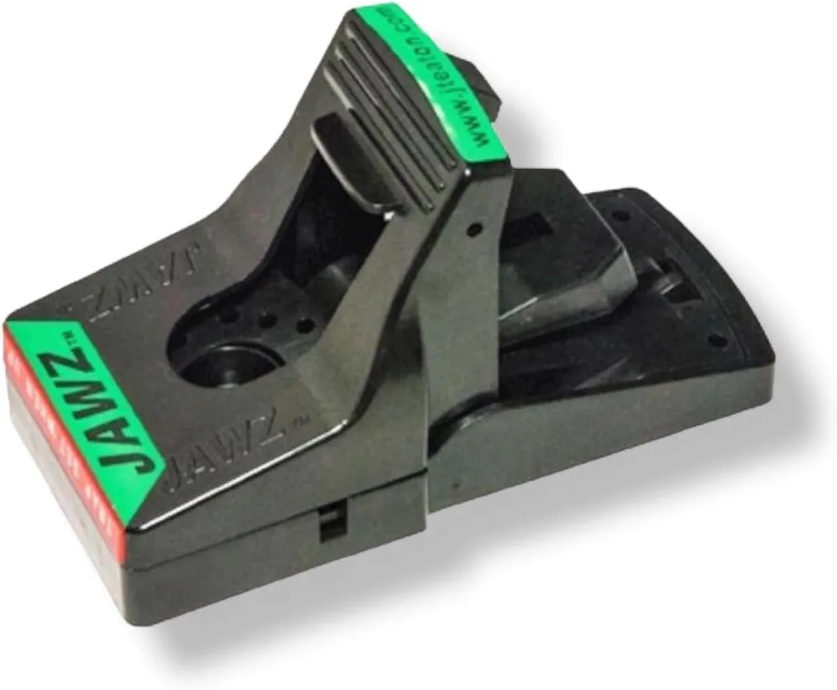 Black plastic rat trap with open jaws and red indicator label visible