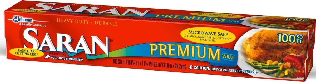 Clear plastic wrap roll in rectangular cardboard dispenser box, 12.2 by 2.1 by 2.1 inches