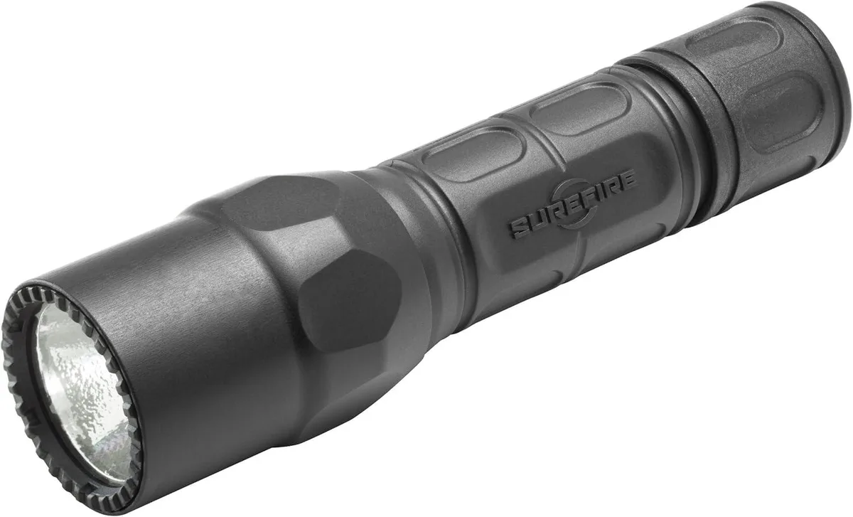 Black tactical flashlight with textured grip and aluminium bezel
