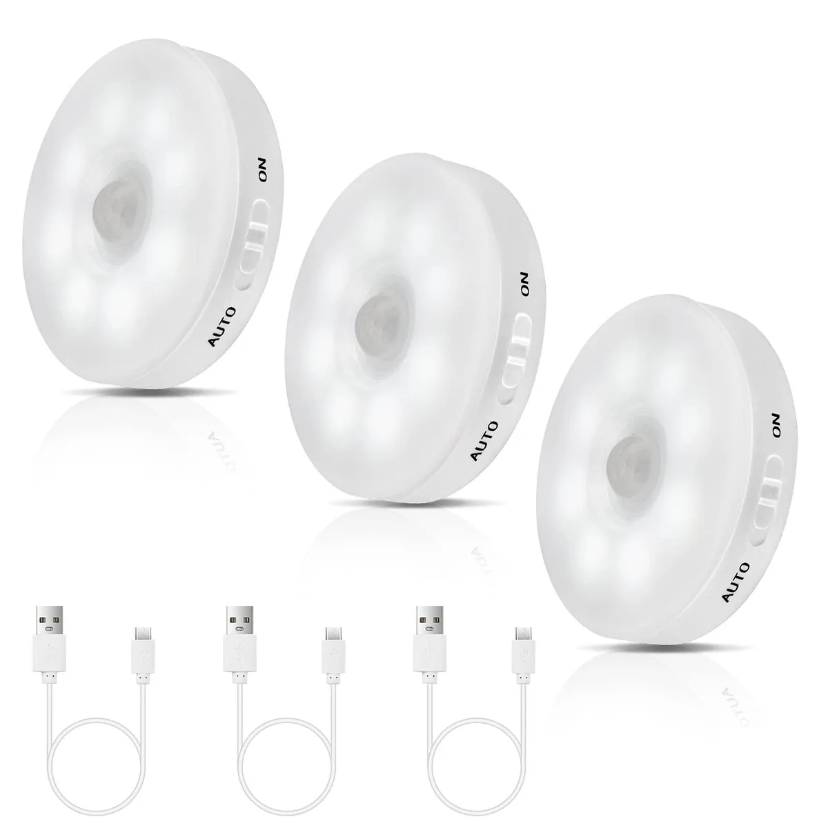Three white round LED lights with magnetic plates and USB cords
