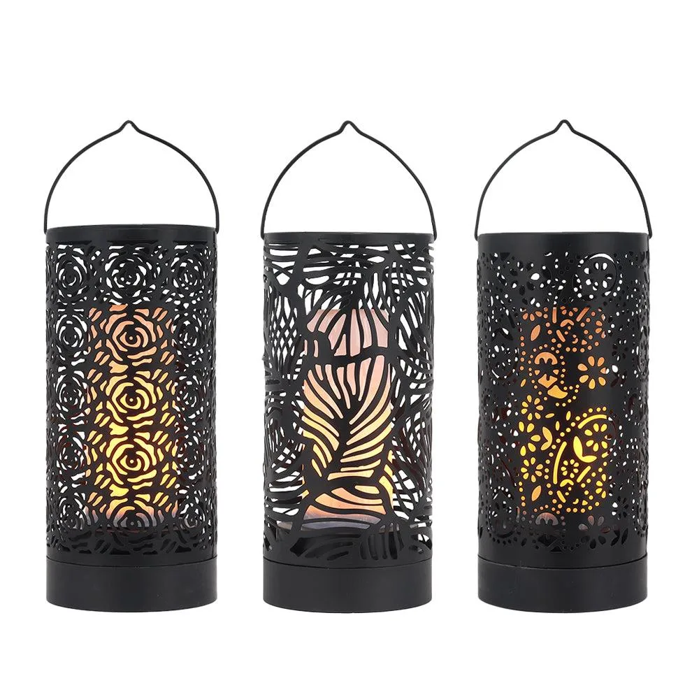 Set of three 7-inch metal lanterns with hollow floral patterns and handles