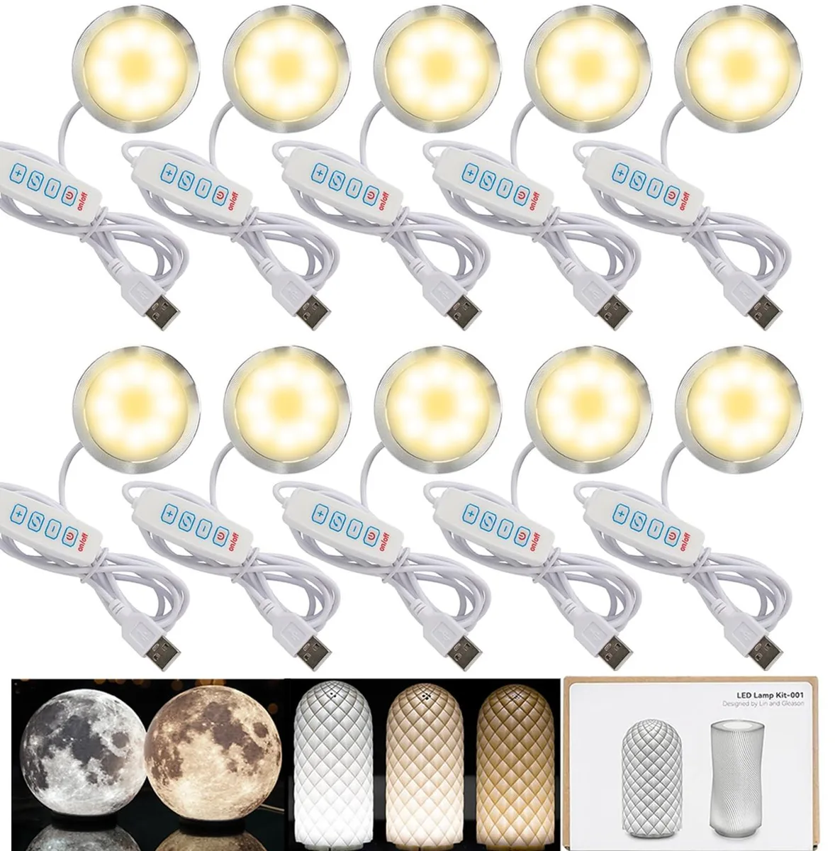 Ten small aluminium puck lights with USB cables on a table