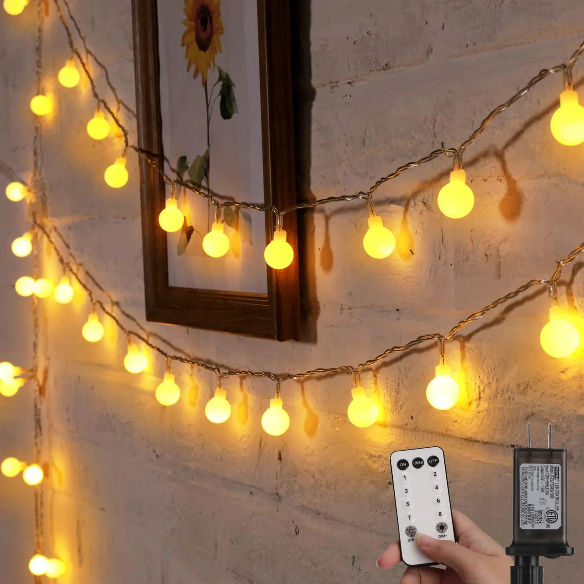 A 33 ft string of 100 warm white LED globe lights on blue wire with remote control