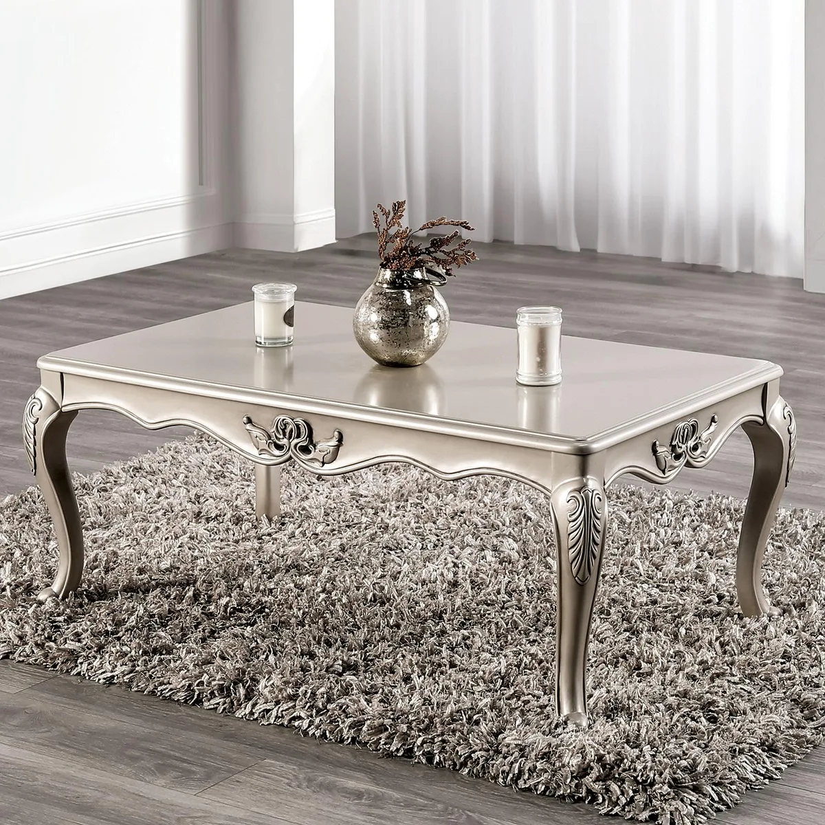 Champagne-finished solid wood coffee table with curved cabriole legs and carved details