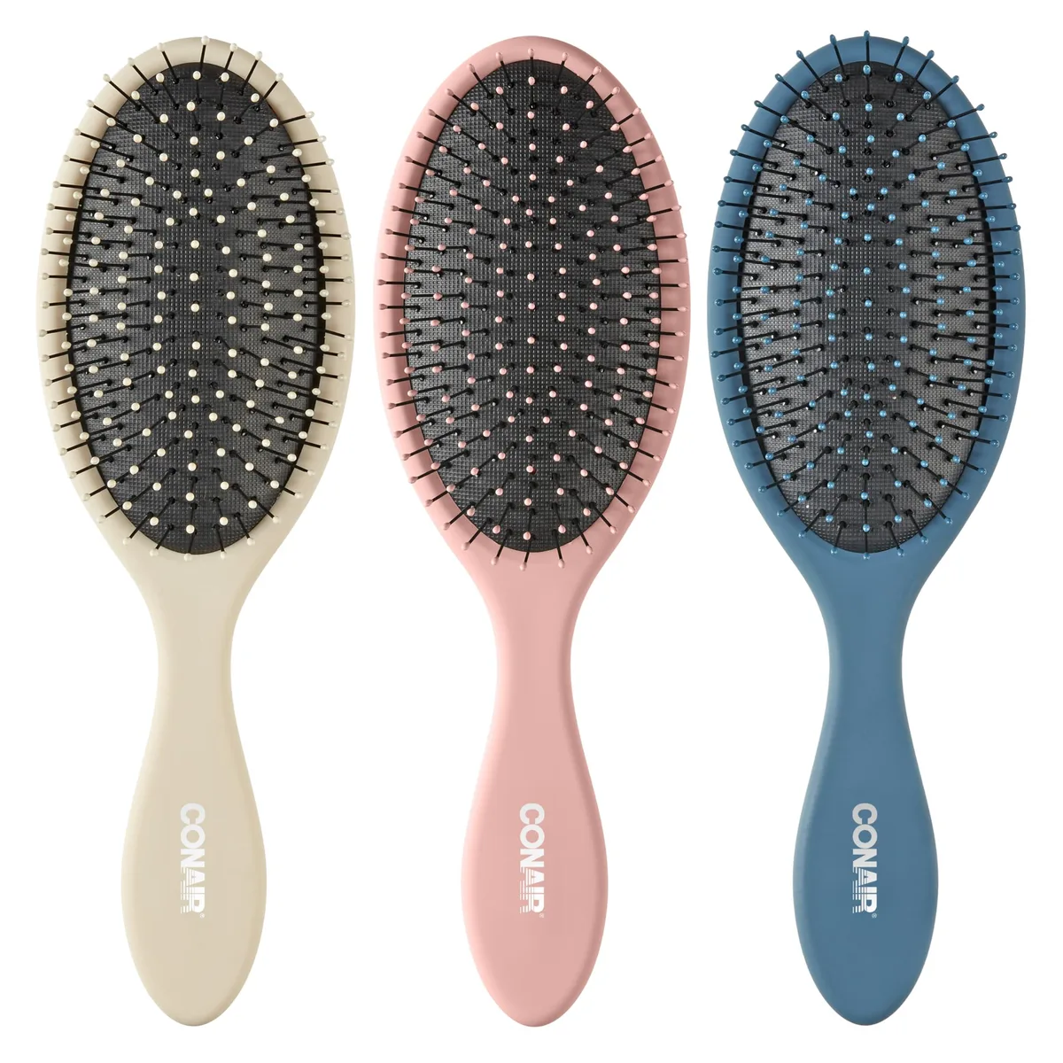 Three pastel Conair detangling brushes in beige, navy and coral with ball-tipped bristles and cushioned bases